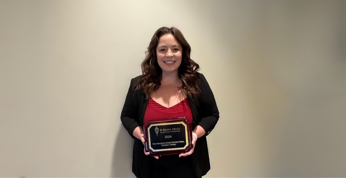 Speech and Debate Coach Marissa Mayo holding the Derryberry Award