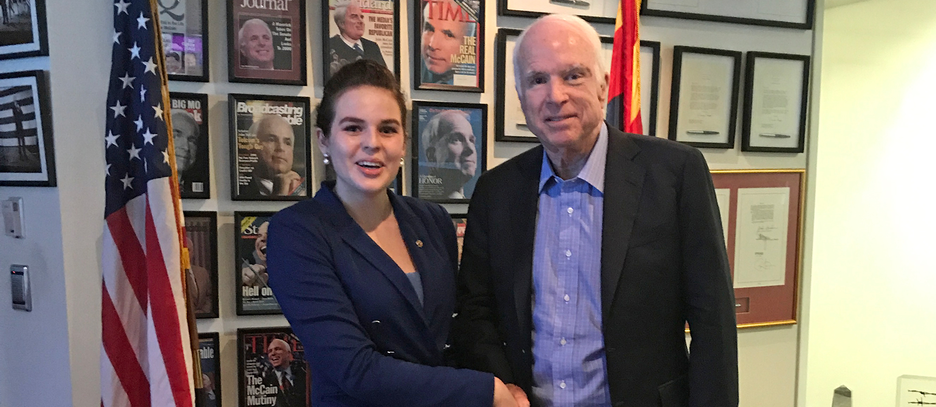 Simpson College graduate Erin Magoffie shakes hands with U.S. Senator John McCain